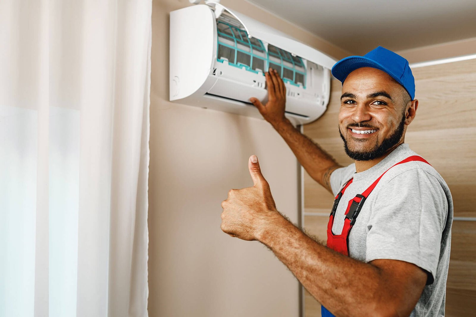 Technician installing split system air conditioner indoor unit
